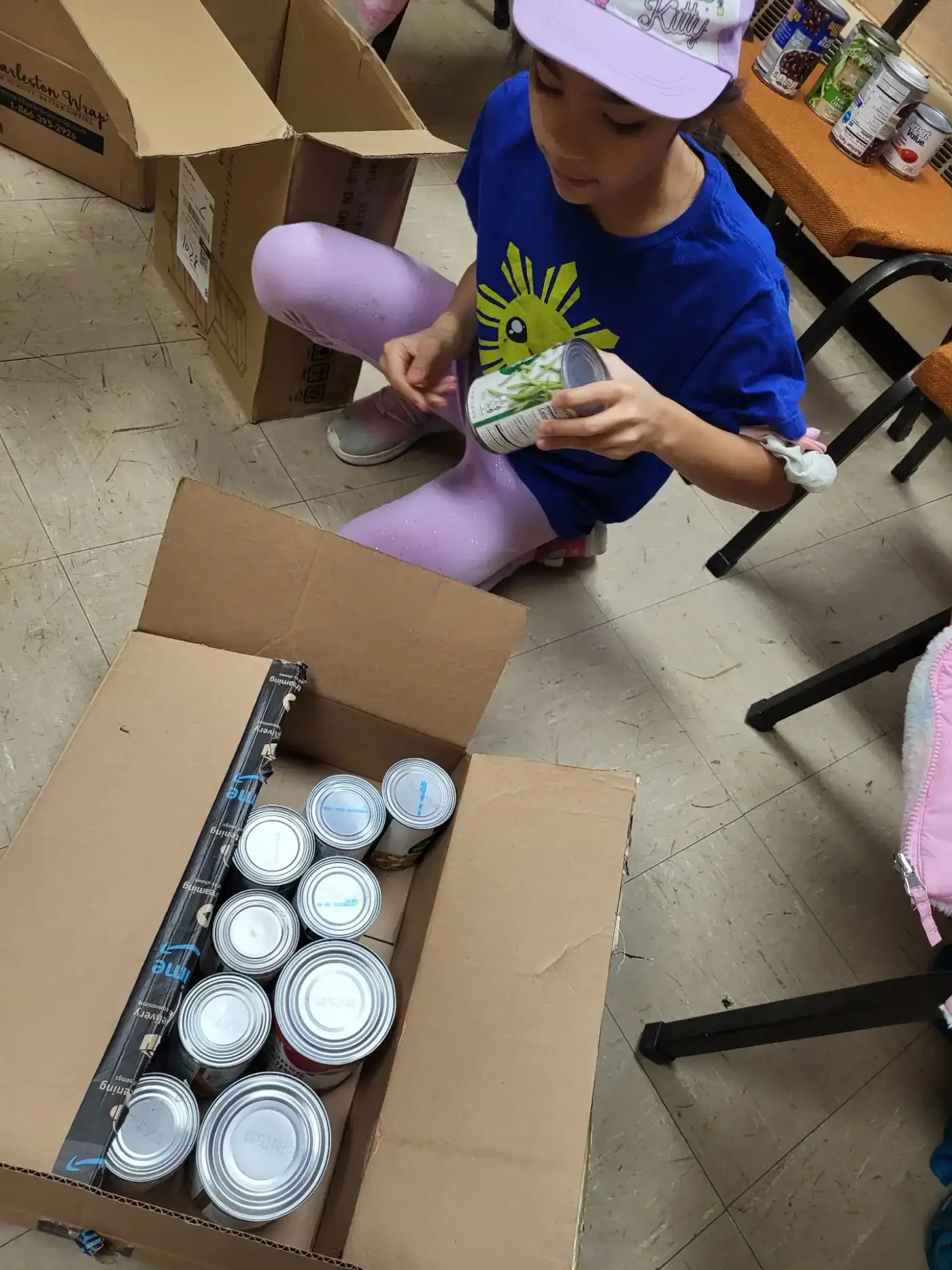Packing canned goods into a donation box