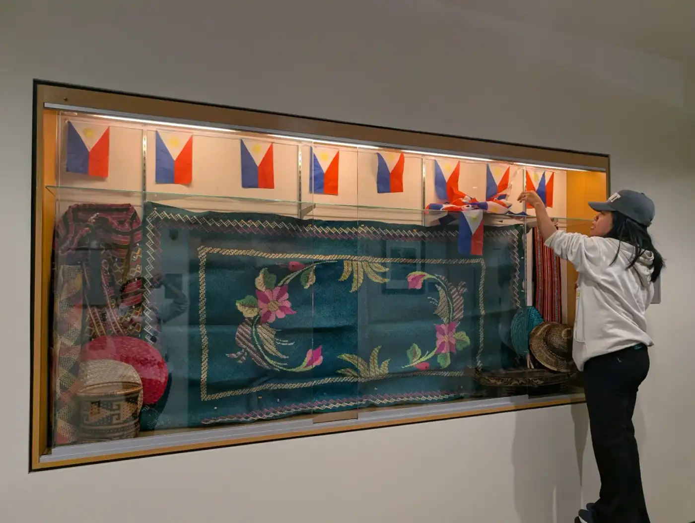 Preparing the cultural display for the Paaralang Pilipino event